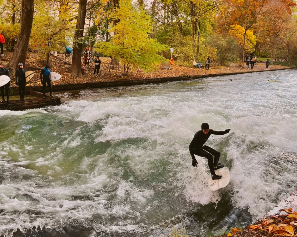 Surfing the Eisbachwelle in the Englischer Garten in Munich